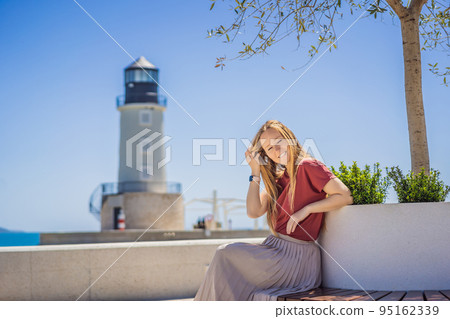 Woman tourist enjoying the views of Architecture and luxury yachts in Lustica Bay, Montenegro. Travel around Montenegro concept. Go Everywhere Woman tourist enjoying the views of Architecture and luxury yachts in Lustica Bay, Montenegro. Travel around Montenegro concept. Go Everywhere 95162339