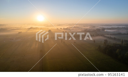 Dramatic Aerial Drone Shot of a beautiful Green and Yellow Agricultural Plantations Bordering with Dramatic Aerial Drone Shot of a beautiful Green and Yellow Agricultural Plantations Bordering with 95163141