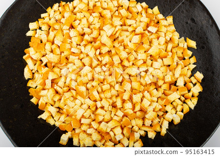 Raw Chopped Orange Peel, Zest on Black Plate Raw Chopped Orange Peel, Zest on Black Plate 95163415