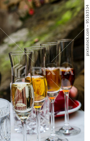 A tasting set of dessert wines in glass glasses. A tasting set of dessert wines in glass glasses. 95163534