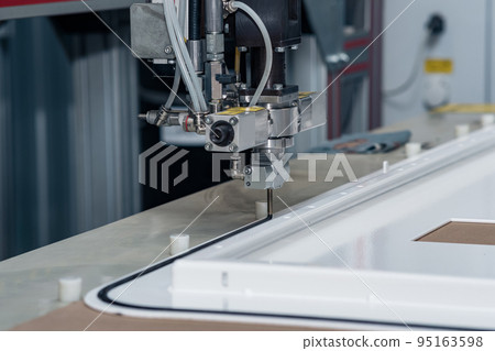 industrial robotic dosing dispenser machine applies a hardening sealant to the metal door blank 95163598