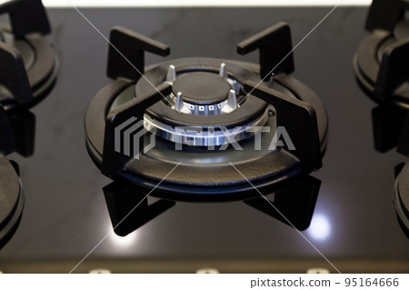 Modern kitchen and black glass ceramic built-in gas oven detail 95164666