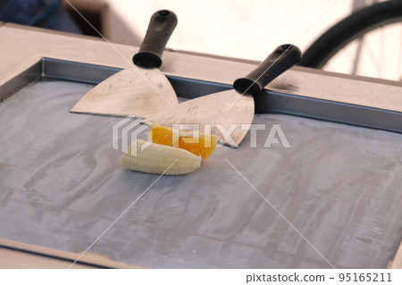 Making thai banana and orange ice cream outdoors Making thai banana and orange ice cream outdoors 95165211