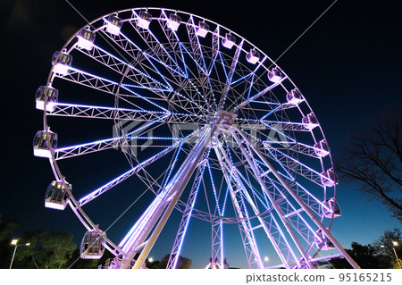 Big ferris wheel at night, glowing with lights at night Big ferris wheel at night, glowing with lights at night 95165215