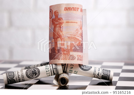 Russian rubles and American dollars on a chessboard Russian rubles and American dollars on a chessboard 95165216