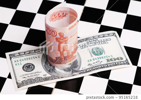 Russian rubles and American dollars on a chessboard Russian rubles and American dollars on a chessboard 95165218