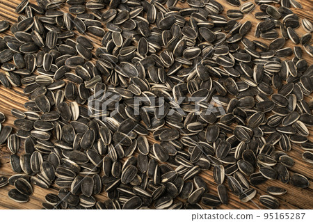 Sunflower Seeds, Striped Raw Seeds on Wood Background Texture Top View Sunflower Seeds, Striped Raw Seeds on Wood Background Texture Top View 95165287