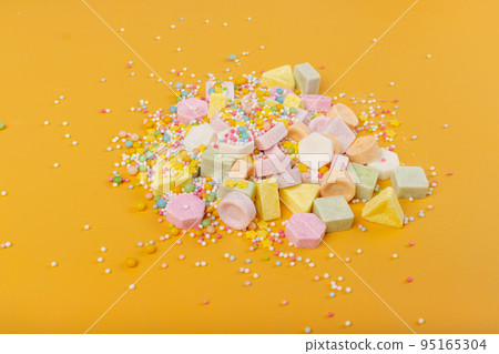 Tablet Candies on Yellow Background, Compressed Tablets 95165304