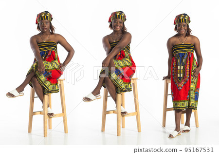 Full length 20s African American woman sit on stool smile and happy confident. Young Adult female wear colorful African ethnic design dress express trendy stylish elegant, white background isolated Full length 20s African American woman sit on stool smile and happy confident. Young Adult female wear colorful African ethnic design dress express trendy stylish elegant, white background isolated 95167531