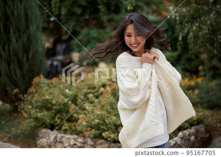 Beautiful asian kazakh brunette woman with flying long hair Beautiful asian kazakh brunette woman with flying long hair 95167705