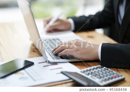 Businessman working at office using laptop. Businessman working at office using laptop. 95168436