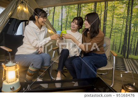 Young women enjoying home camping Ie Camp 95168476
