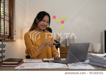 Asian Accountant video call with client by laptop. work from home concept Asian Accountant video call with client by laptop. work from home concept 95168581
