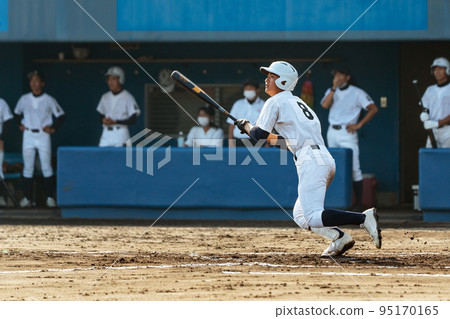 High school baseball player hitting a hit in a baseball game 95170165