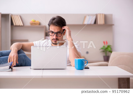 Young male freelancer working from home 95170962