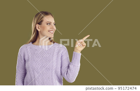 Smiling beautiful woman with index finger pointing sideways on place for copy space. Smiling beautiful woman with index finger pointing sideways on place for copy space. 95172474