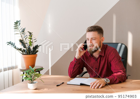 Business bearded man is talking on phone and plans to meet daily and write Business bearded man is talking on phone and plans to meet daily and write 95174903