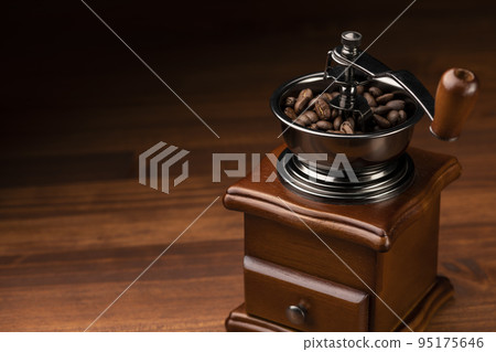 Grind coffee beans with a coffee grinder 95175646