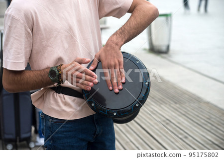 Closeup of hands of musician playing arabian drum in the street 95175802
