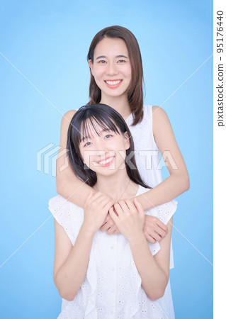 Two women in white clothes fit in a photo 95176440