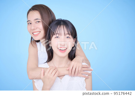 Two women in white clothes fit in a photo 95176442