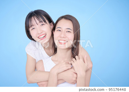 Two women in white clothes fit in a photo 95176448