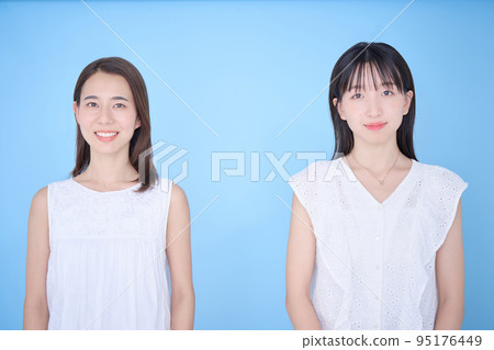Two women in white clothes fit in a photo 95176449