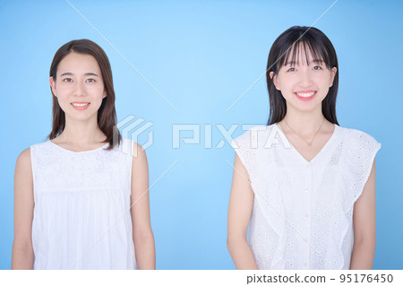 Two women in white clothes fit in a photo 95176450