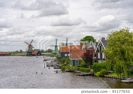 Rural landscape with windmill in Zaanse Schans. Holland, Netherlands. Authentic Zaandam mill. Beautiful Netherland landscape. 95177650