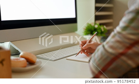 A female student doing her homework, taking notes or writing something in her notebook 95178452
