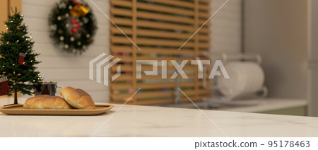 Marble kitchen countertop with copy space, bread and Christmas tree. close-up image Marble kitchen countertop with copy space, bread and Christmas tree. close-up image 95178463