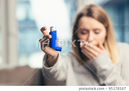 Beautiful girl while holding inhaler 95178587