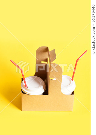 Coffee cups with white lids and red straws 95179446
