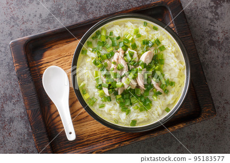 Dak Gomtang Korean Chicken Soup served with rice and green onion close-up in a bowl. Horizontal top view 95183577