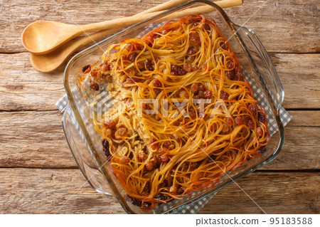 yerushalmi kugel a traditional eastern European Jewish food made of noodles and burnt sugar close-up in a glass bowl. Horizontal top view 95183588