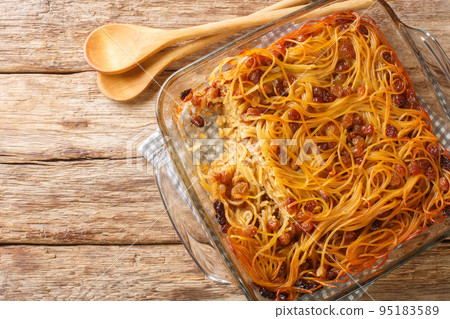 Jerusalem noodle kugel a Jewish pie for Shabbat Kodesh close-up in a glass bowl. Horizontal top view Jerusalem noodle kugel a Jewish pie for Shabbat Kodesh close-up in a glass bowl. Horizontal top view 95183589