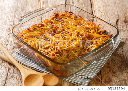 Jerusalem noodle kugel a Jewish pie for Shabbat Kodesh close-up in a glass bowl. Horizontal Jerusalem noodle kugel a Jewish pie for Shabbat Kodesh close-up in a glass bowl. Horizontal 95183594