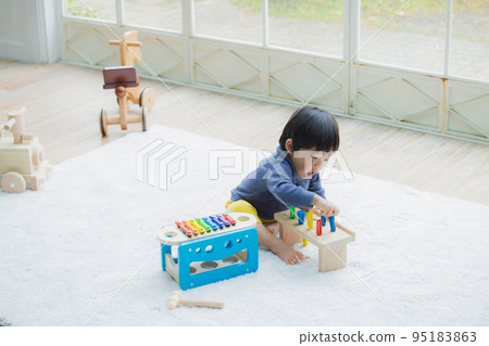 A boy playing with a toy 95183863