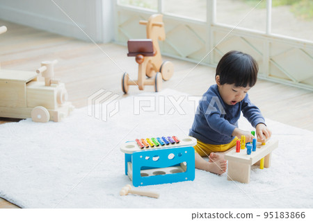 A boy playing with a toy A boy playing with a toy 95183866