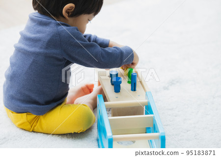 A boy playing with a toy 95183871