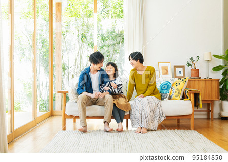 Family gathering together in the living room of the house Family gathering together in the living room of the house 95184850