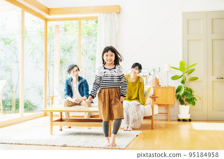 girl running in the living room of the house girl running in the living room of the house 95184958