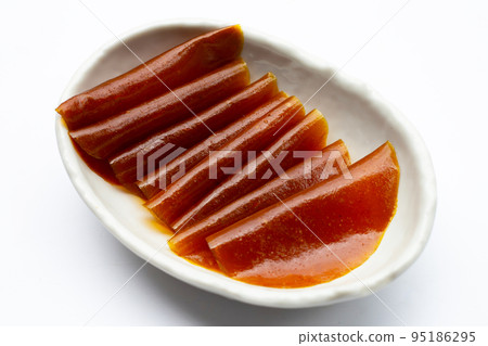 Dried mango paste sheets on white background. 95186295