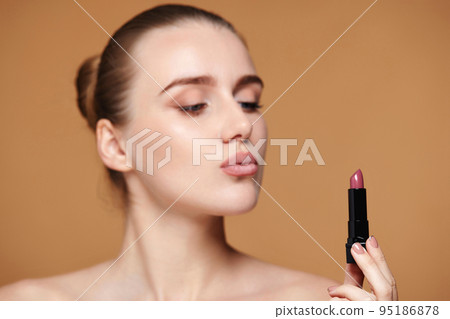 beautiful young woman using trendy pink lipstick beautiful young woman using trendy pink lipstick 95186878