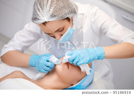 woman during a mechanical face cleansing procedure woman during a mechanical face cleansing procedure 95186919