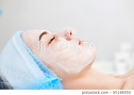 beautiful woman with blue alginate mask on face 95186950
