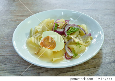boiled salty egg half cut with slice pickled cabbage salad on plate 95187553