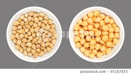 Chickpeas, dried and boiled, in white bowls, over gray. Raw and cooked chick peas, high in protein seeds of Cicer arietinum, a legume, also known as garbanzo beans or gram. Isolated, macro food photo. Chickpeas, dried and boiled, in white bowls, over gray. Raw and cooked chick peas, high in protein seeds of Cicer arietinum, a legume, also known as garbanzo beans or gram. Isolated, macro food photo. 95187855
