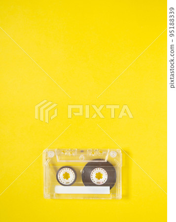 Vintage audio tape cassette on yellow background. 95188339