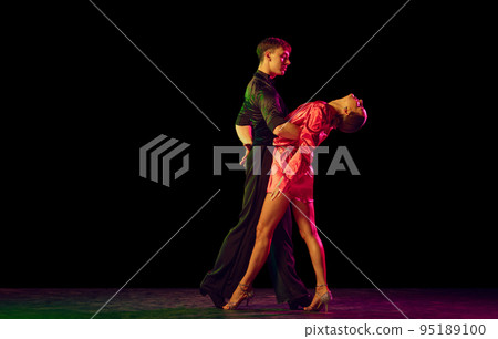 Feelings in dance. Emotional dancers dancing ballroom dance isolated on dark background. Concept of art, dance, beauty, music, style. 95189100